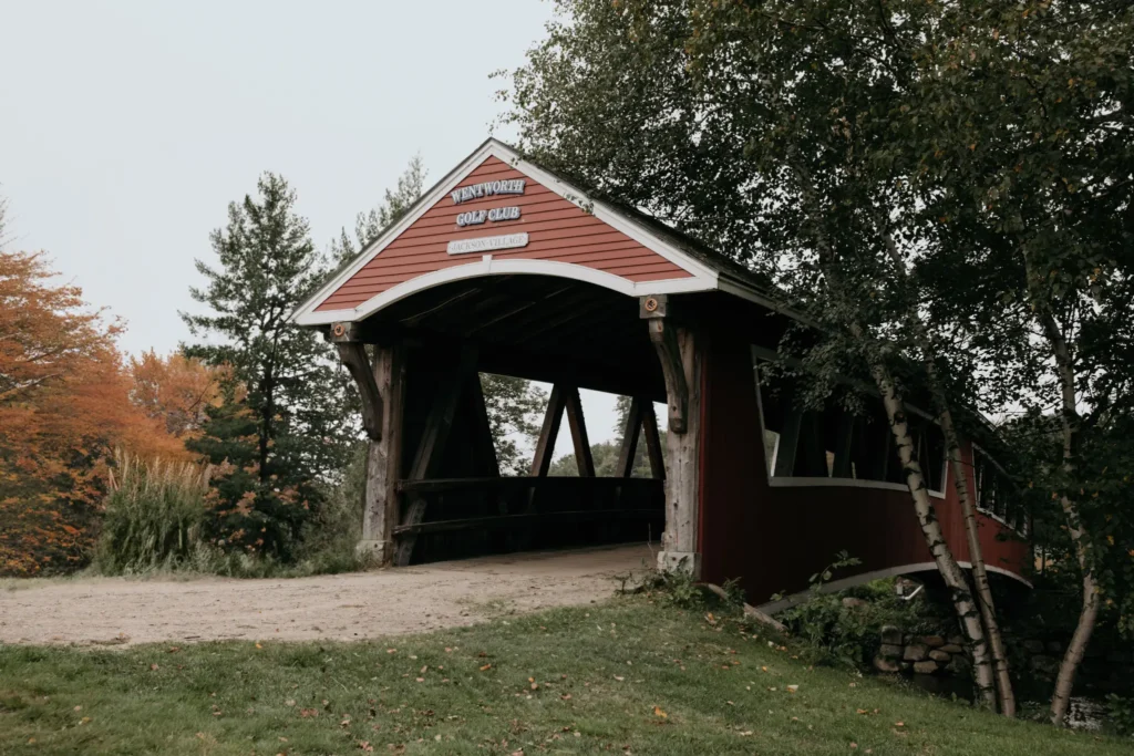 Exterior view of a guest cottage at The Wentworth featuring a private porch and hot tub.
