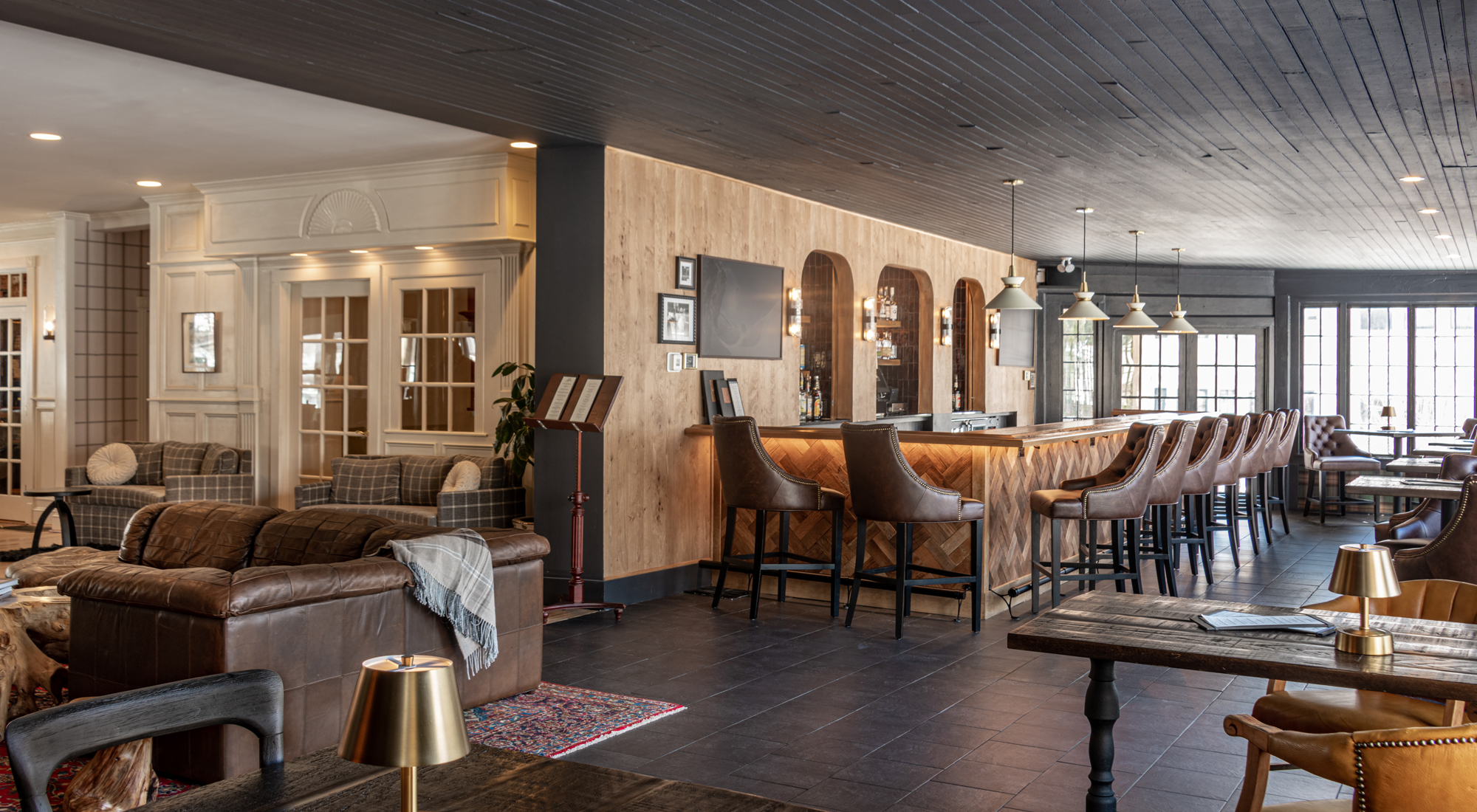 a bar with brown leather chairs, sofa and tables at the Wentworth.