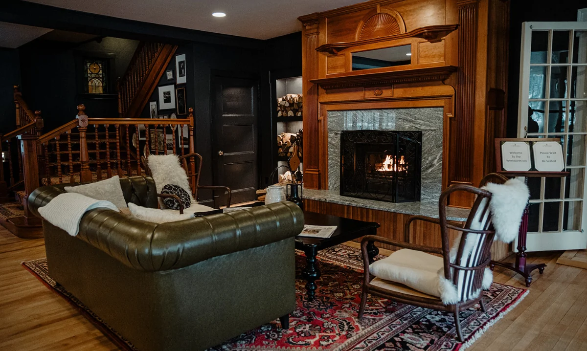 A meeting room with furniture and a fireplace at the Wentworth